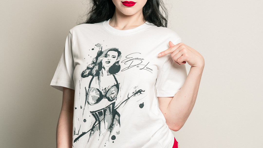 Woman wearing a white t-shirt with a graphic design and red underwear against a plain background